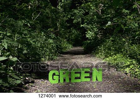 Stock Image - Green turf block letters spelling out GREEN on a footpath in nature. Fotosearch