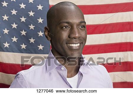 Happy man in front of American flag View Large Photo Image Stock Photograph - Happy man in front of American flag. Fotosearch