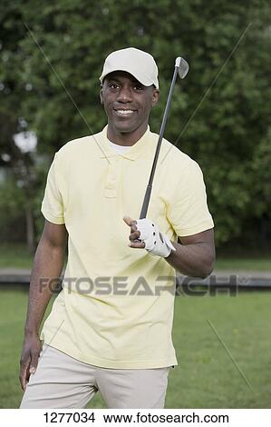 Picture - Man relaxing on golf course. Fotosearch