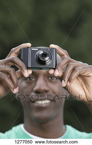 Man using digital camera View Large Photo Image Stock Image - Man using digital camera. Fotosearch