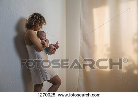 Stock Photo - Mother holding baby . Fotosearch