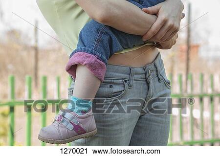 Stock Image - Mother holding child. Fotosearch