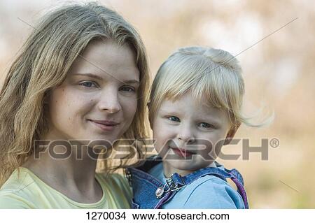 Picture - Mother holding daughter. Fotosearch