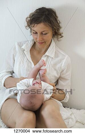 Mother looking down at daughter View Large Photo Image Picture - Mother looking down at daughter. Fotosearch