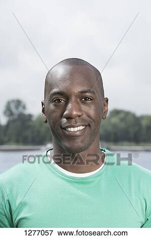 Portrait of smiling man in green t-shirt View Large Photo Image Stock Photo - Portrait of smiling man in green t-shirt. Fotosearch