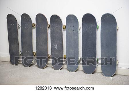 Row of skateboards against wall, one has a painting of an American Indian on it View Large Photo Image Stock Image - Row of skateboards against wall, one has a painting of an American Indian on it. Fotosearch