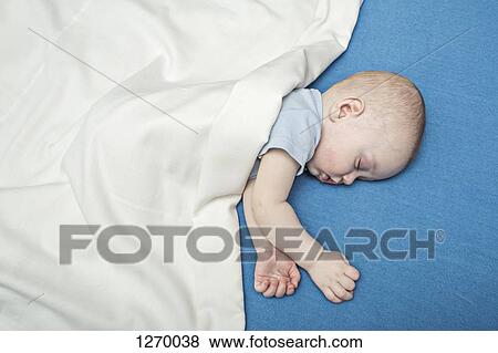 Sleeping baby on bed under blanket View Large Photo Image Stock Photo - Sleeping baby on bed under blanket. Fotosearch