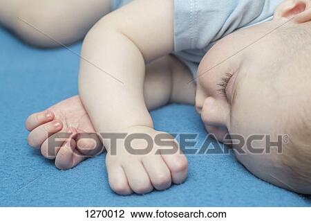 Sleeping baby on blue blanket View Large Photo Image Stock Image - Sleeping baby on blue blanket. Fotosearch