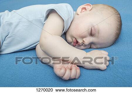 Sleeping baby on blue blanket View Large Photo Image Stock Image - Sleeping baby on blue blanket. Fotosearch