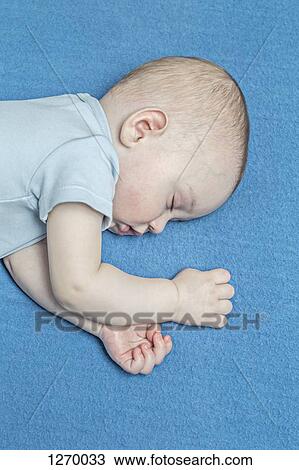 Sleeping baby on blue blanket View Large Photo Image Stock Image - Sleeping baby on blue blanket. Fotosearch