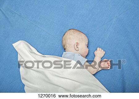 Sleeping baby on blue blanket View Large Photo Image Stock Photograph - Sleeping baby on blue blanket. Fotosearch