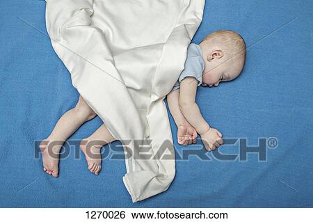 Sleeping baby on blue blanket View Large Photo Image Stock Photograph - Sleeping baby on blue blanket. Fotosearch