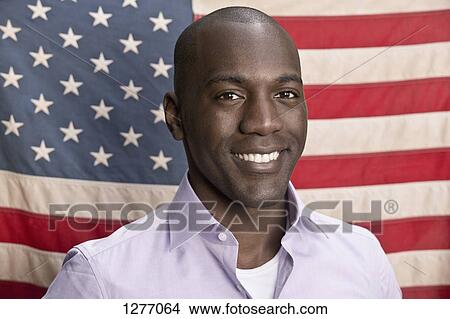 Smiling man in front of American flag View Large Photo Image Picture - Smiling man in front of American flag. Fotosearch