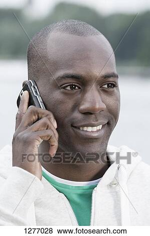 Smiling man on phone View Large Photo Image Stock Photo - Smiling man on phone. Fotosearch