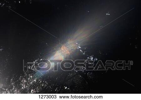 Sunbeams shining through dense tree branches creating a spectrum View Large Photo Image Stock Image - Sunbeams shining through dense tree branches creating a spectrum. Fotosearch