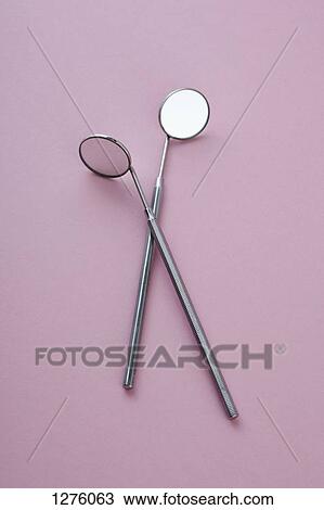 Stock Image - Two angled dental mirrors . Fotosearch