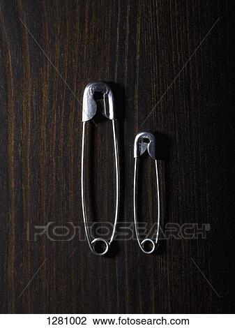 Two different sized safety pins, side by side View Large Photo Image Stock Image - Two different sized safety pins, side by side. Fotosearch