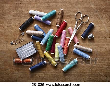Various spools of colored thread in a pile with scissors, safety pins and sewing needles View Large Photo Image Stock Photography - Various spools of colored thread in a pile with scissors, safety pins and sewing needles. Fotosearch