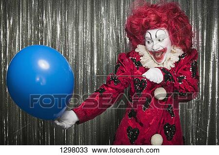 A clown getting ready to pop a balloon with a needle View Large Photo Image Stock Image - A clown getting ready to pop a balloon with a needle . Fotosearch