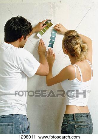 Stock Image - A couple choosing colour samples. Fotosearch