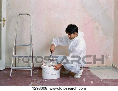 A man holding paint roller View Large Photo Image Stock Photo - A man holding paint roller. Fotosearch