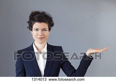 A smiling mid adult woman with her palm out in anticipation View Large Photo Image Stock Image - A smiling mid adult woman with her palm out in anticipation. Fotosearch