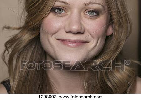 Stock Image - A woman looking at camera, close-up. Fotosearch