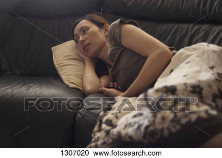 A woman resting on sofa View Large Photo Image Stock Image - A woman resting on sofa. Fotosearch
