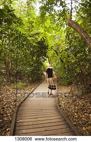A woman walking on path View Large Photo Image Stock Photograph - A woman walking on path. Fotosearch
