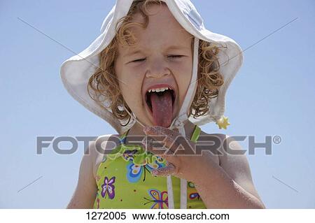 Stock Photography - A young girl sticking out her tongue in disgust. Fotosearch
