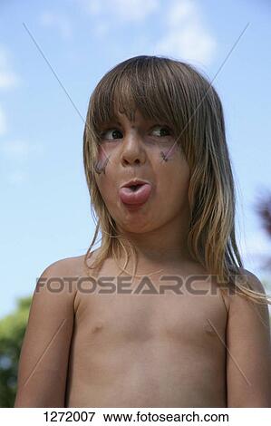 A young girl with a dirty face, sticking her tongue out playfully View Large Photo Image Stock Photo - A young girl with a dirty face, sticking her tongue out playfully. Fotosearch
