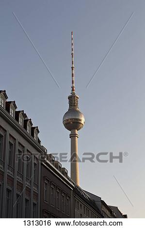 Stock Photograph - Alexanderplatz Television Tower, behind apartment buildings, Berlin, Germany. Fotosearch