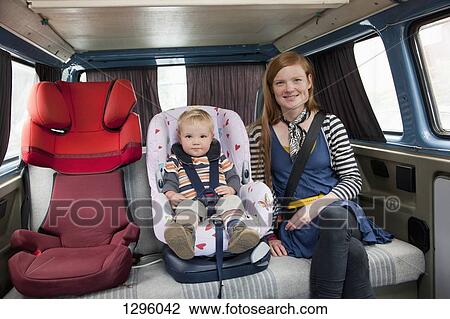 Baby boy in car seat with mother in back seat View Large Photo Image Stock Image - Baby boy in car seat with mother in back seat. Fotosearch