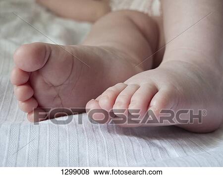Stock Photo - Baby's feet, close-up. Fotosearch