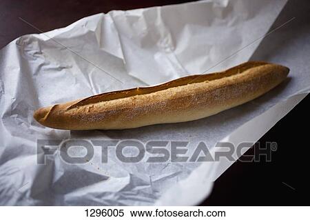 Baguette on paper, close-up View Large Photo Image Stock Photography - Baguette on paper, close-up. Fotosearch