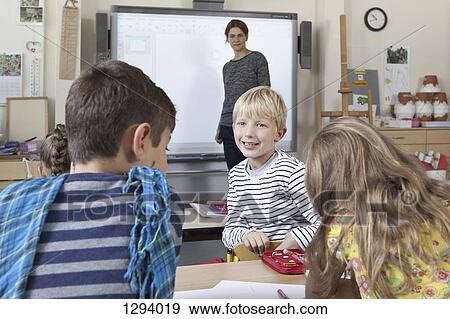 Boy in classroom talking with students View Large Photo Image Stock Photo - Boy in classroom talking with students. Fotosearch