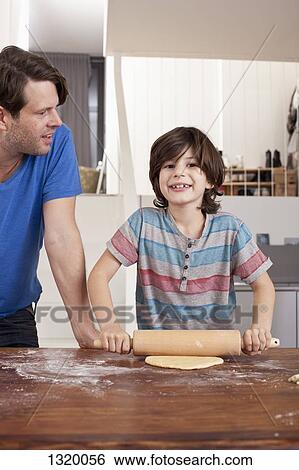Boy rolling dough for cookies View Large Photo Image Stock Photograph - Boy rolling dough for cookies. Fotosearch