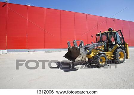 Bulldozer beside red wall View Large Photo Image Stock Photograph - Bulldozer beside red wall. Fotosearch