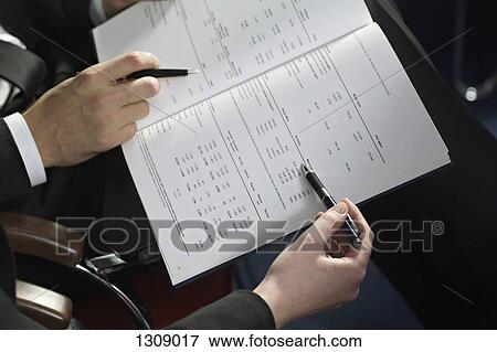 Business people checking document View Large Photo Image Stock Photo - Business people checking document. Fotosearch