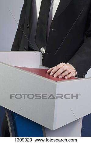 Businessman at lectern View Large Photo Image Stock Image - Businessman at lectern. Fotosearch