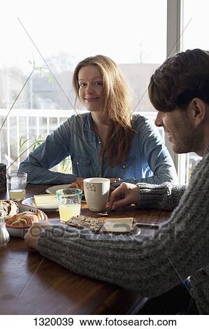 Couple having breakfast at dining table View Large Photo Image Stock Photo - Couple having breakfast at dining table. Fotosearch