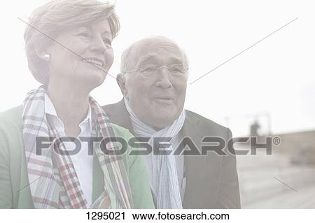 Stock Image - Couple looking away and smiling, close-up. Fotosearch