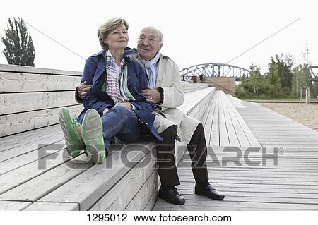 Couple sitting on steps in park View Large Photo Image Stock Image - Couple sitting on steps in park. Fotosearch