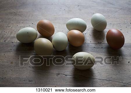 Stock Image - Eggs on wooden table, close-up. Fotosearch