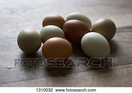 Stock Image - Eggs on wooden table, close-up. Fotosearch
