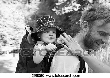 Father carrying his son in baby carrier View Large Photo Image Stock Image - Father carrying his son in baby carrier. Fotosearch