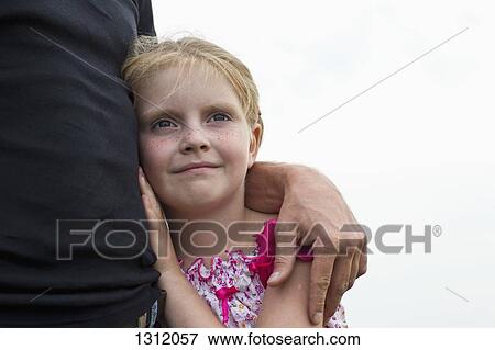 Stock Photo - Father with daughter looking away. Fotosearch