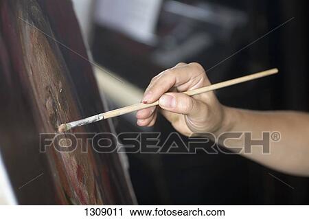 Stock Image - Female artist painting, close-up. Fotosearch
