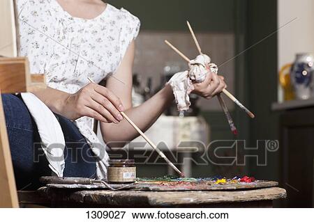 Stock Photo - Female artist using palette, close-up. Fotosearch