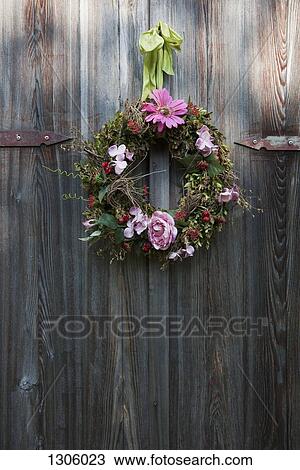 Flower wreath hanging on wooden door View Large Photo Image Stock Image - Flower wreath hanging on wooden door. Fotosearch